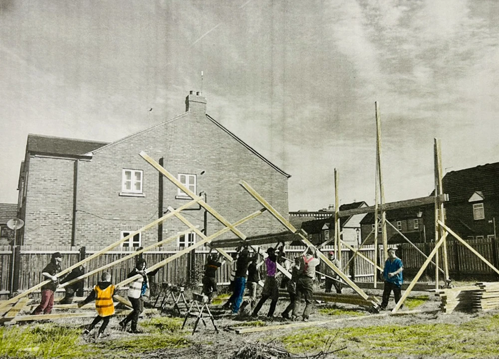 Community volunteers working together to raise wooden beams during a neighborhood construction or renovation project.